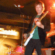 No its not Eddie Izzard, it's Phil Barton, and he plays guitar